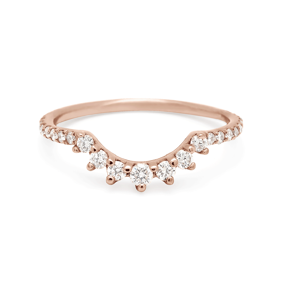A curve band with 7 white diamonds at the center and white diamond pave around the rest of the band set in rose gold., Rose Gold