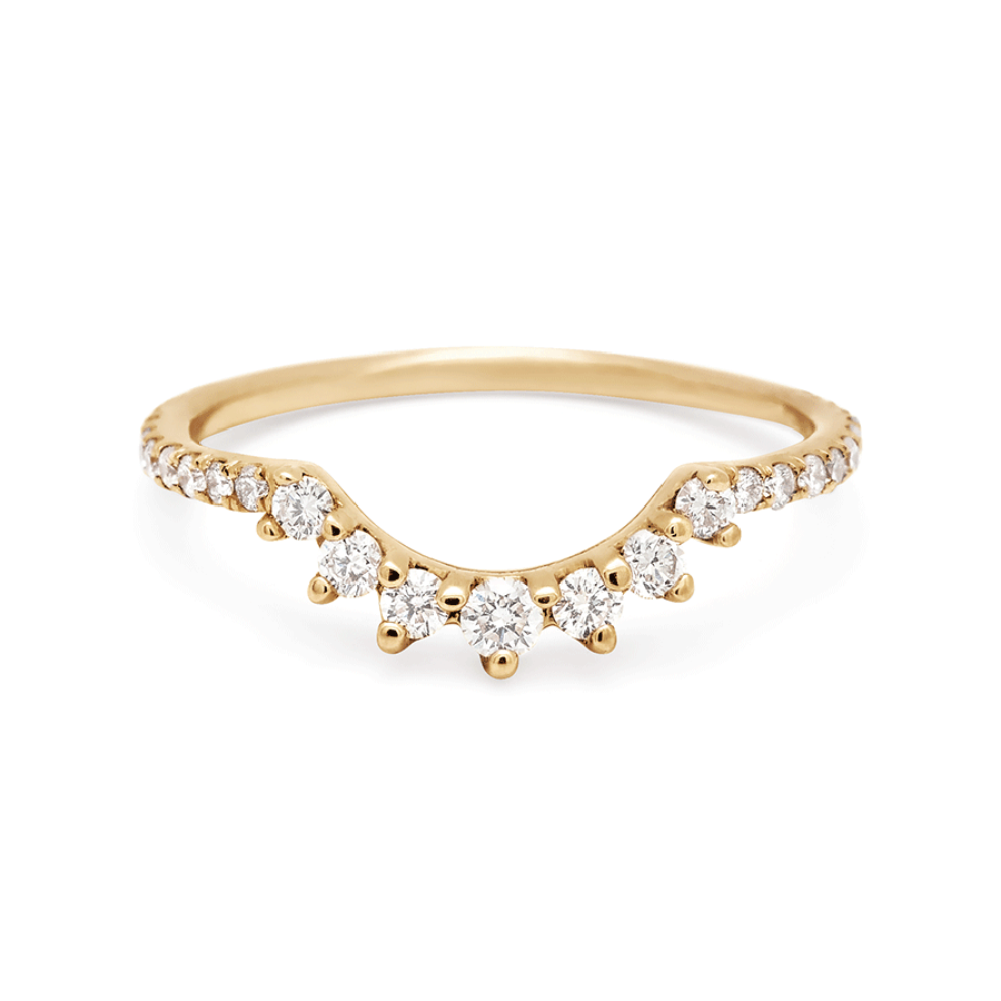 A curve band with 7 white diamonds at the center and white diamond pave around the rest of the band set in yellow gold., Yellow Gold