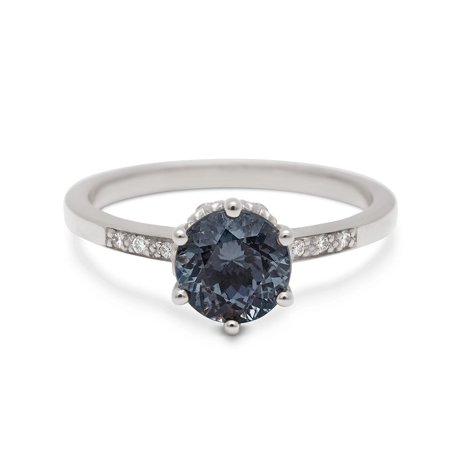 A solitaire ring with a round grey spinel with white diamond pave on either side set in white gold., White Gold