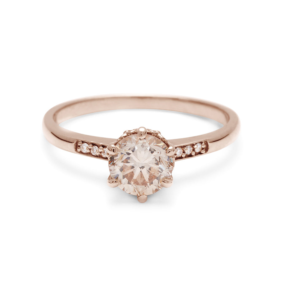 A solitaire ring with a round brilliant cut 0.75ct champagne diamond with white diamond pave on either side set in rose gold., Rose Gold