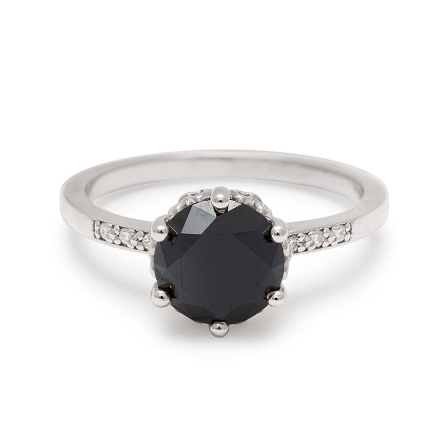 A solitaire ring with a round 1.50ct black diamond with white diamond pave on either side set in white gold., White Gold