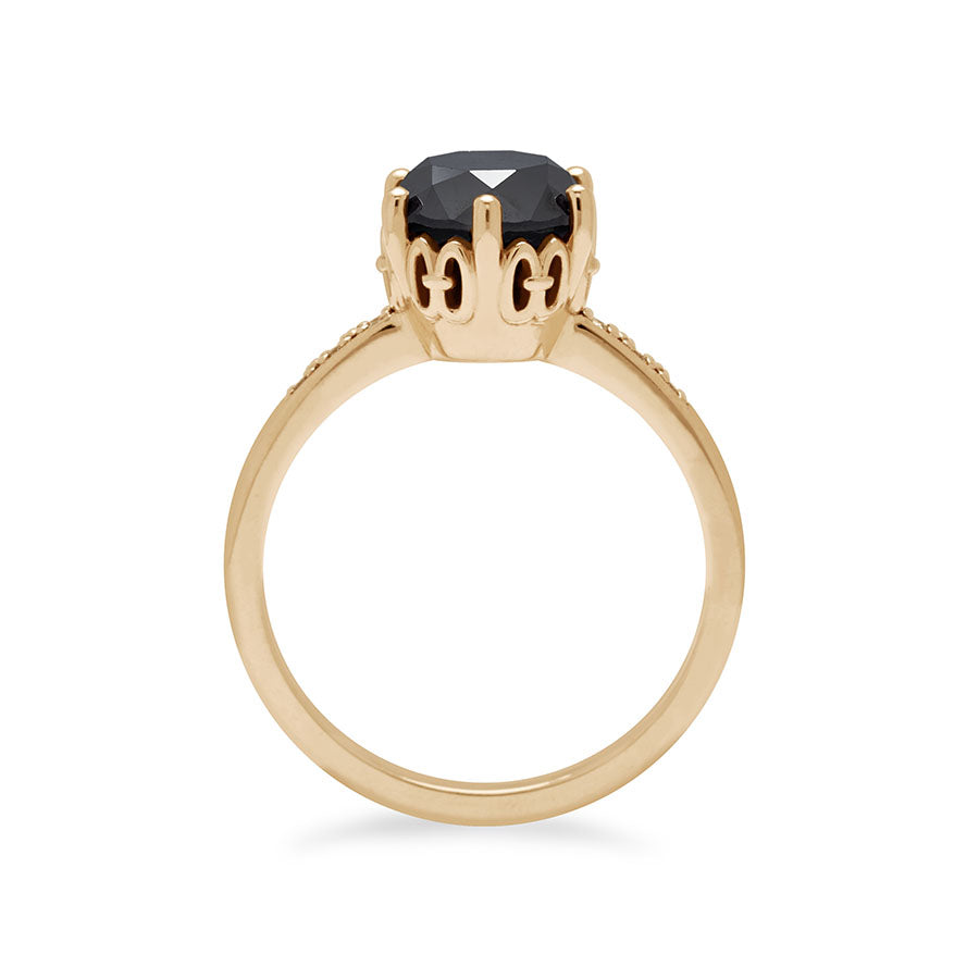 Side view of a solitaire ring with a round 1.50ct black diamond with white diamond pave on either side set in yellow gold., Yellow Gold