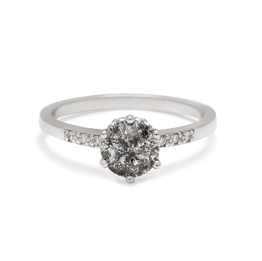 A solitaire ring with a 1.00ct round galaxy grey diamond with white diamond pave on either side set in yellow gold., White Gold
