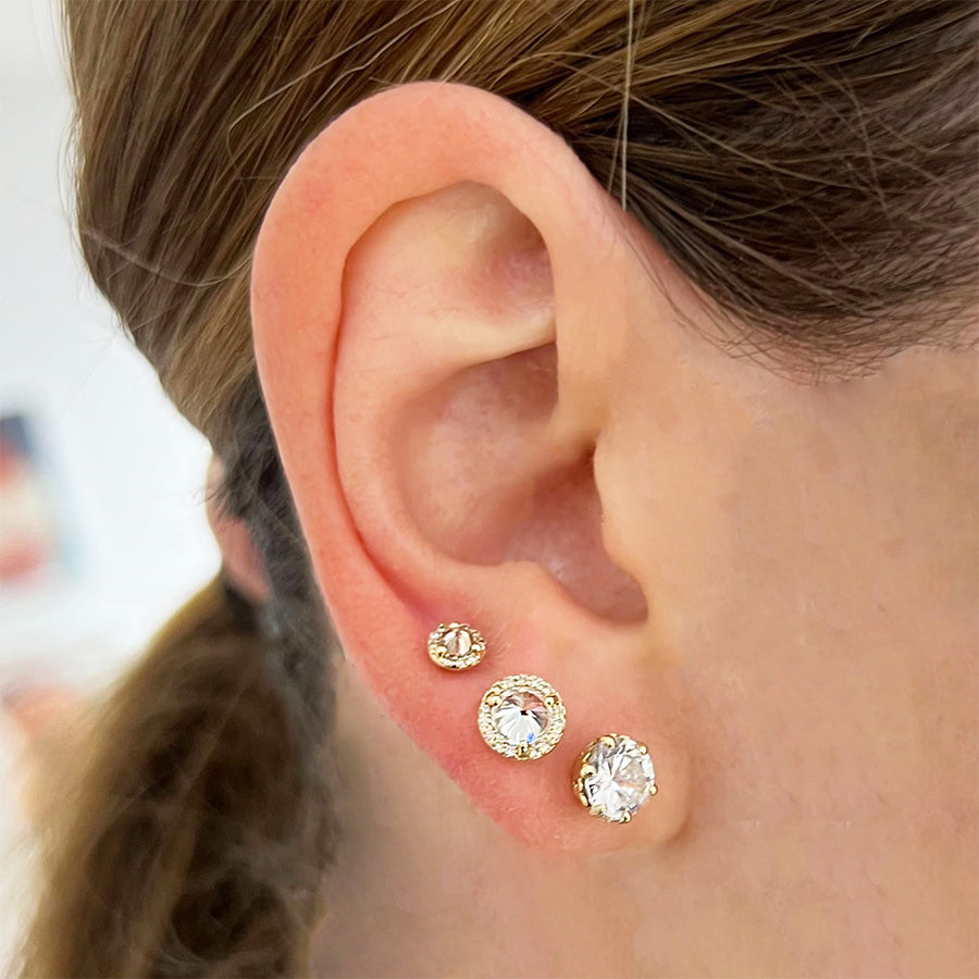 Female ear wearing Hazeline Solitaire Stud Earrings - 14k Gold & White Diamond