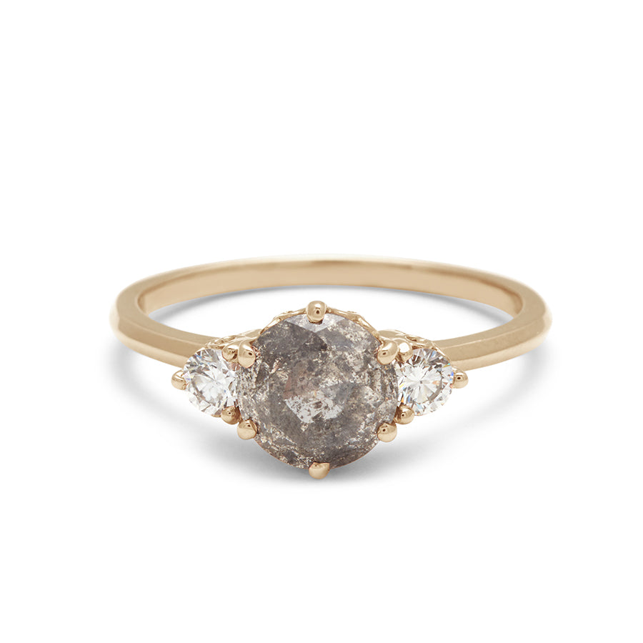 A three stone engagement ring with a round shape grey diamond center stone with two white diamond round side stones set in a yellow gold band., Yellow Gold