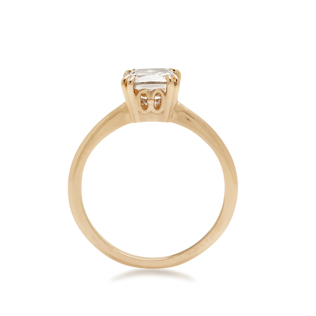 Side view of a solitaire ring with a cushion cut 1.50ct champagne diamond set in yellow gold on a knife edge band.