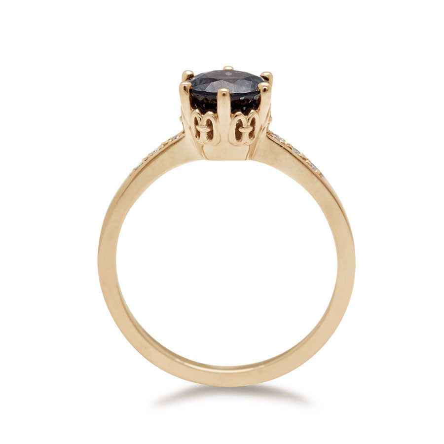 Side view of a solitaire ring with a round grey spinel with white diamond pave on either side set in yellow gold., Yellow Gold