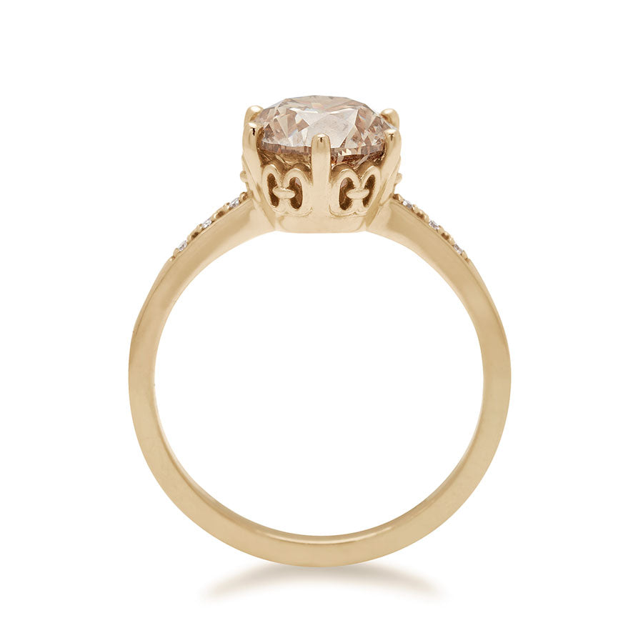 Side view of a solitaire ring with a round 1.50ct champagne diamond with white diamond pave on either side set in yellow gold., Yellow Gold
