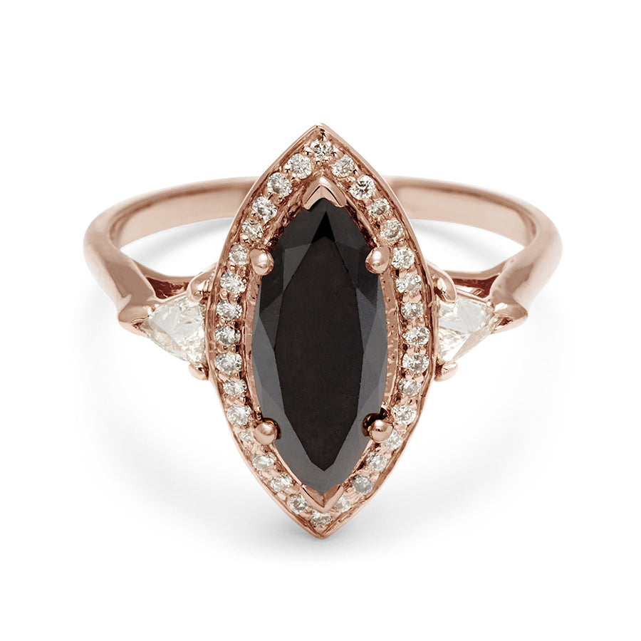 A three stone engagement ring with an marquise shape black diamond center stone surrounded by a white diamond pave halo with two white diamond trillion side stones set in rose gold., Rose Gold