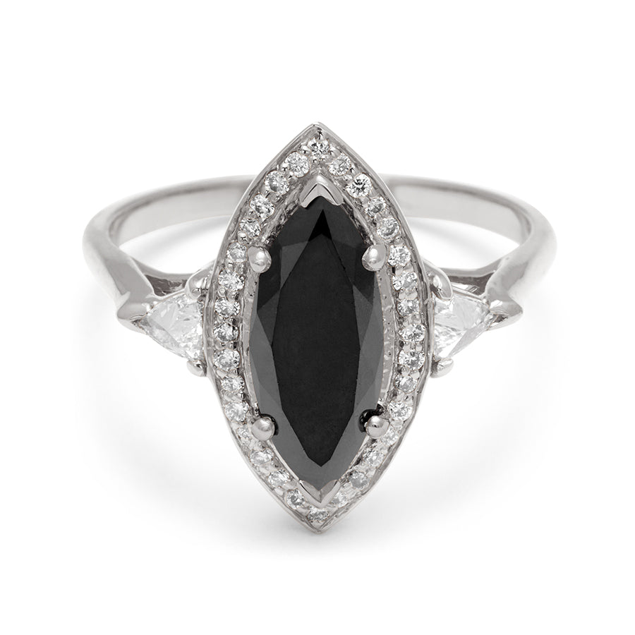 A three stone engagement ring with an marquise shape black diamond center stone surrounded by a white diamond pave halo with two white diamond trillion side stones set in white gold., White Gold
