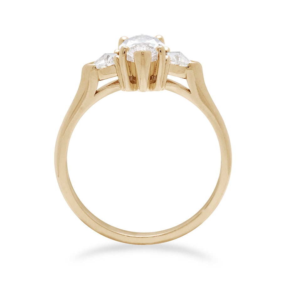 Side view of a three stone engagement ring with a marquise shape brilliant cut 1.00ct white diamond center stone with two white diamond trillion side stones set in yellow gold., Yellow Gold