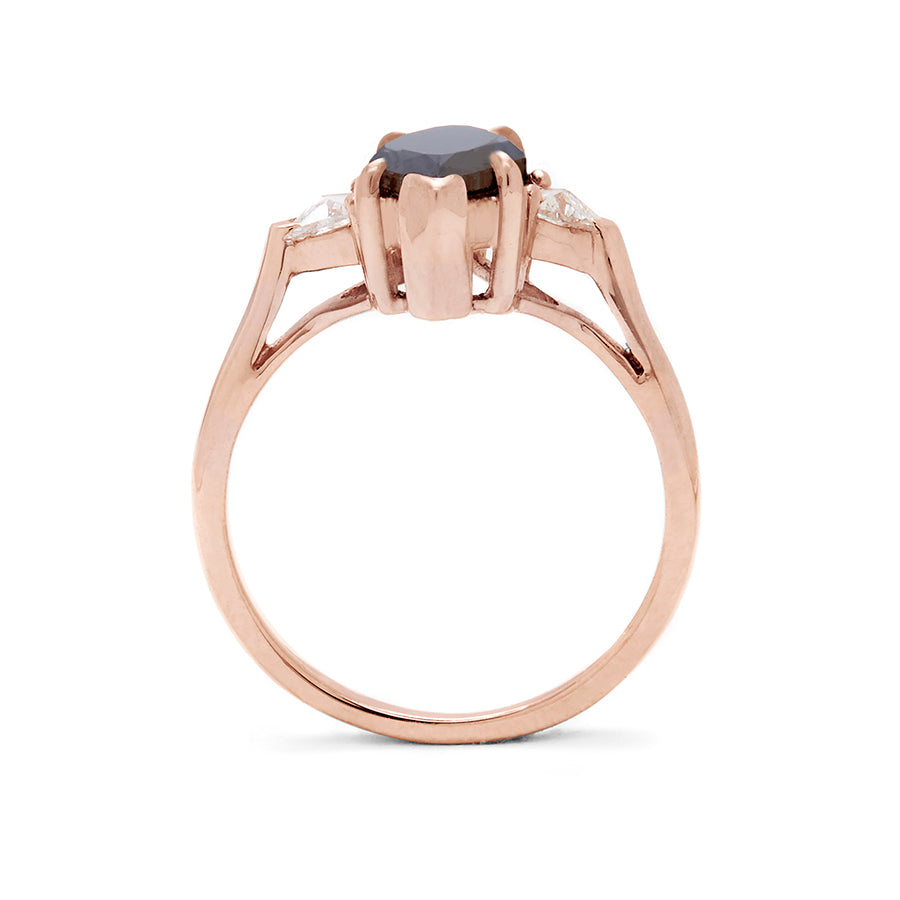 Side view of a three stone engagement ring with a marquise shape 1.25ct black diamond center stone with two white diamond trillion side stones set in rose gold., Rose Gold