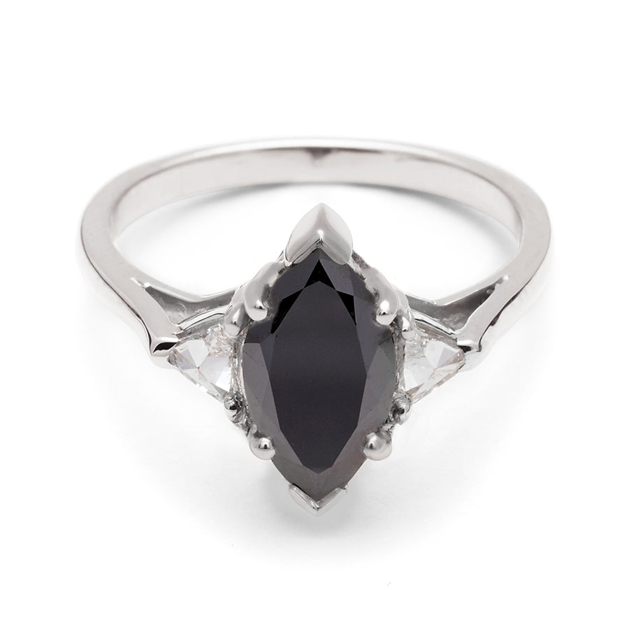 A three stone engagement ring with a marquise shape 1.25ct black diamond center stone with two white diamond trillion side stones set in white gold., White Gold