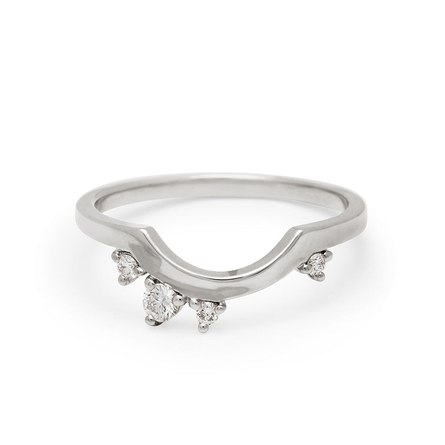 A solid gold band with asymetrical white diamond accent stones set in white gold., White Gold