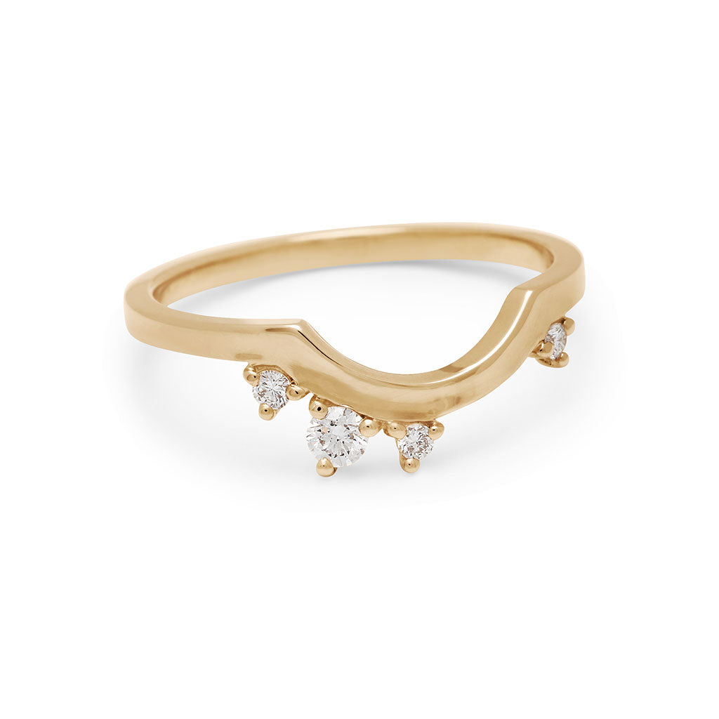Angled view a solid gold band with asymetrical white diamond accent stones set in yellow gold., Yellow Gold