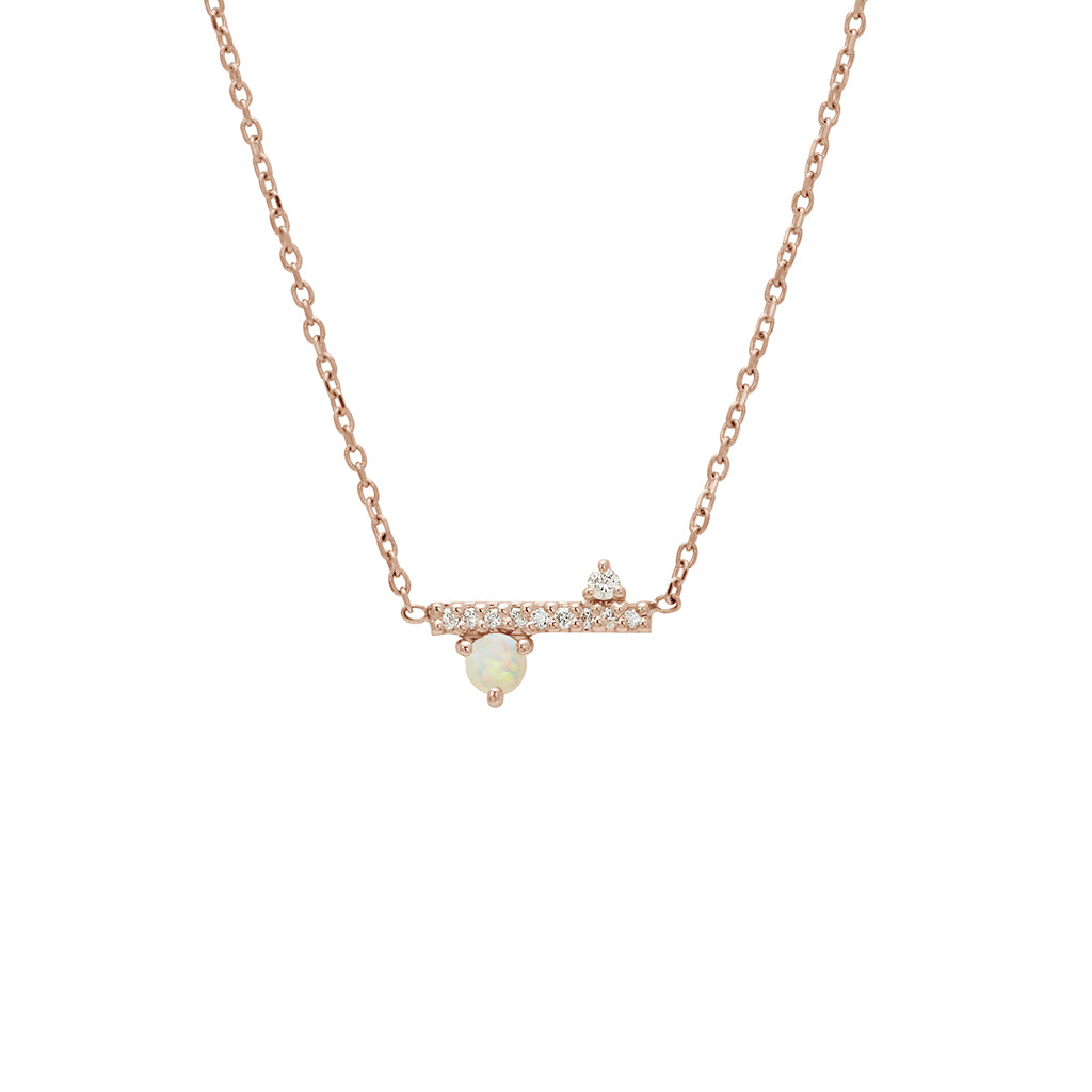 A straight line of white diamond pave with a opal accent stone on one side set in a rose gold necklace chain., Rose Gold