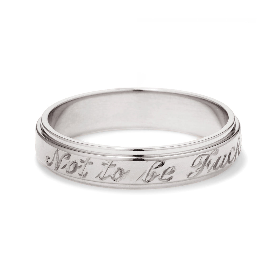 A white gold flat edge band in 3mm with "Not to Be F**ked With" engraved on the outside., White Gold