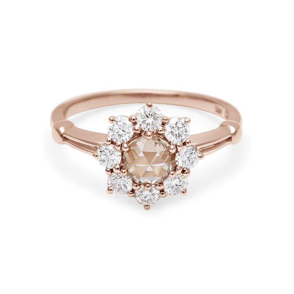 A cluster engagement ring with a white diamond center stone and champagne diamond side stones surrounding it set in 14k yellow gold., Yellow Gold