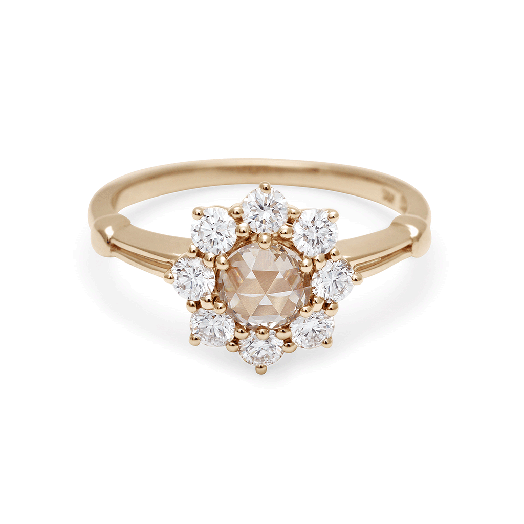 A cluster engagement ring with a rose cut champagne diamond center stone and round white diamond stones surrounding it set in yellow gold., Yellow Gold