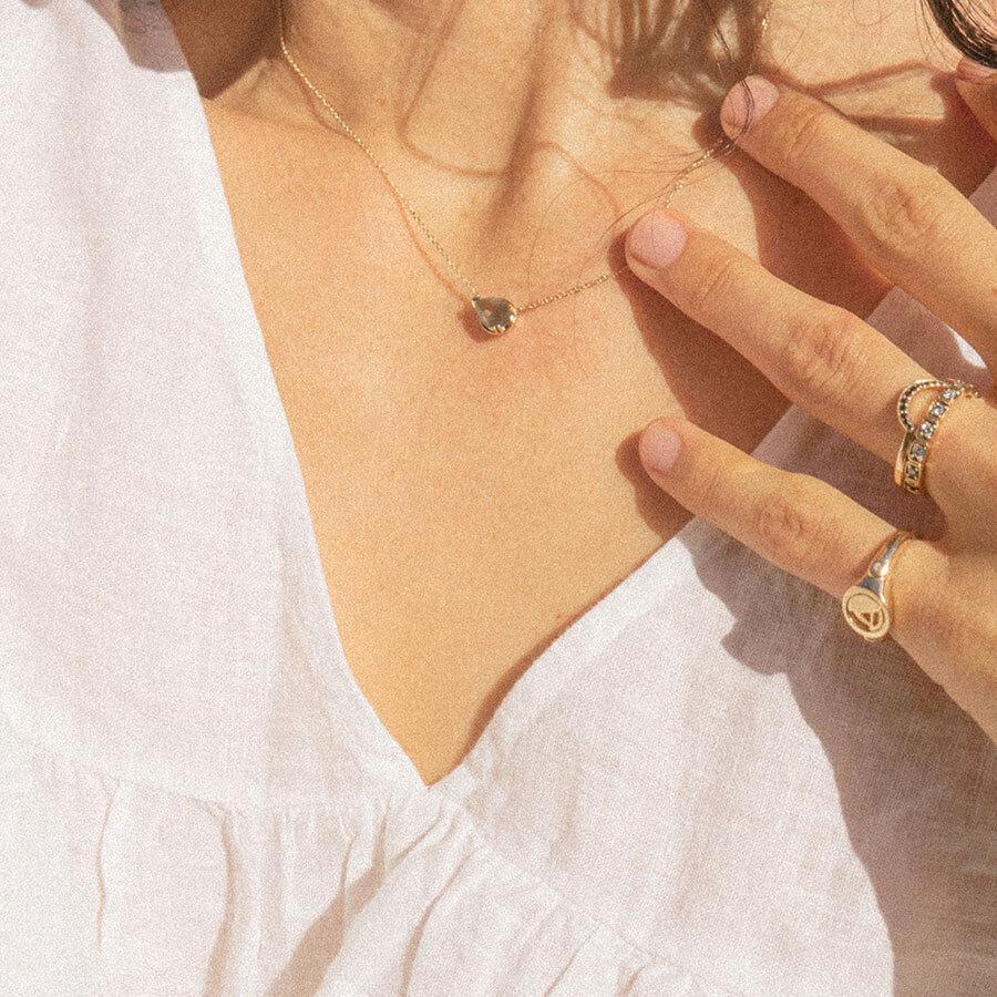 Female wearing Petite Pear Luna Necklace - Yellow Gold & Grey Spinel