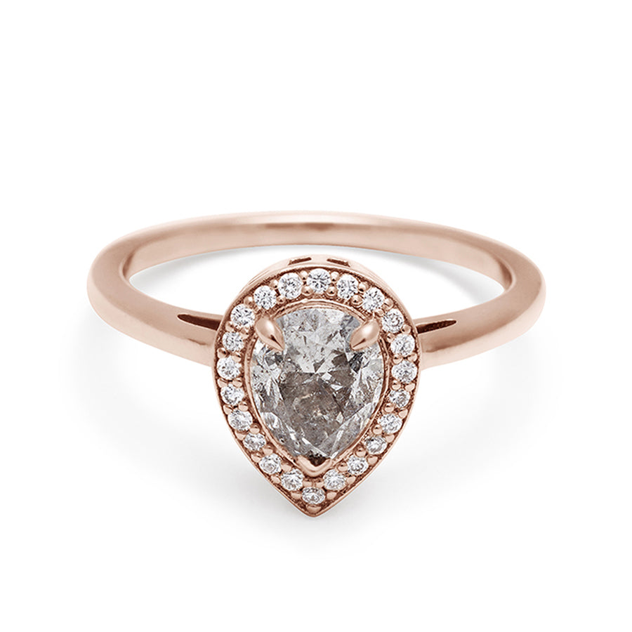 An engagement ring with a pear shape grey diamond center stone surrounded by a white diamond pave halo set in rose gold., Rose Gold