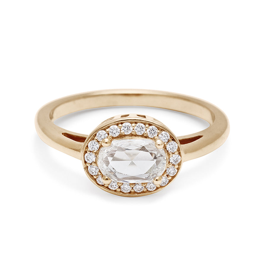 An engagement ring with a rose cut and oval shape white diamond center stone surrounded by a white diamond pave halo set in yellow gold., Yellow Gold