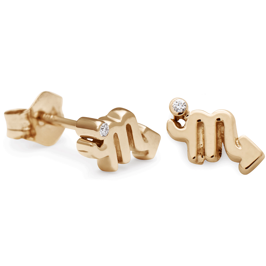 A pair of Scorpio stud earrings set in yellow gold with a white diamond accent stone with one earring angled.