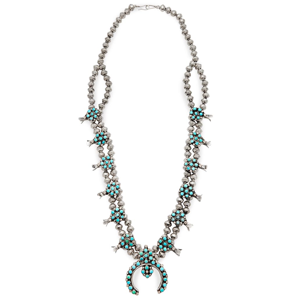 A turquoise stone squash blossom necklace set in sterling silver.