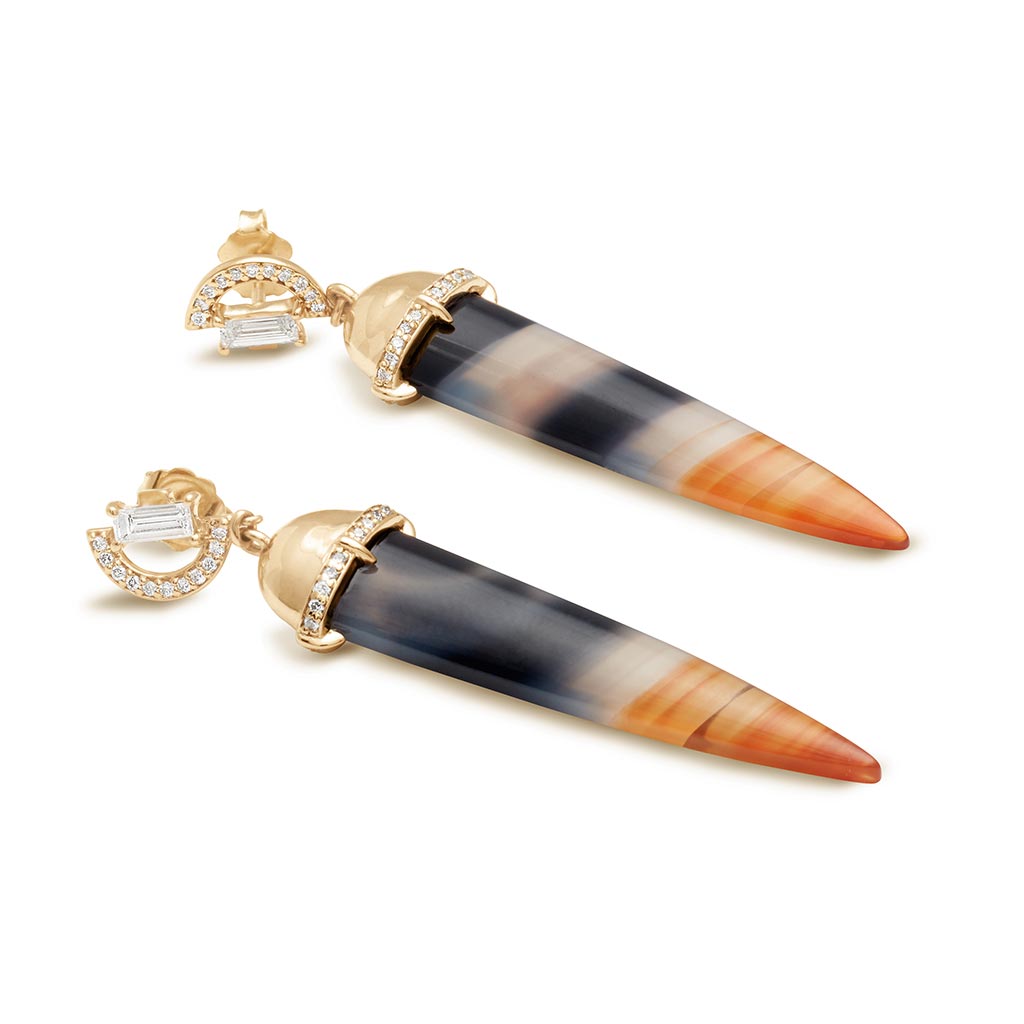 Angled view of a pair of chalcedony drop earrings with a white diamond arc stud at the top set in yellow gold.
