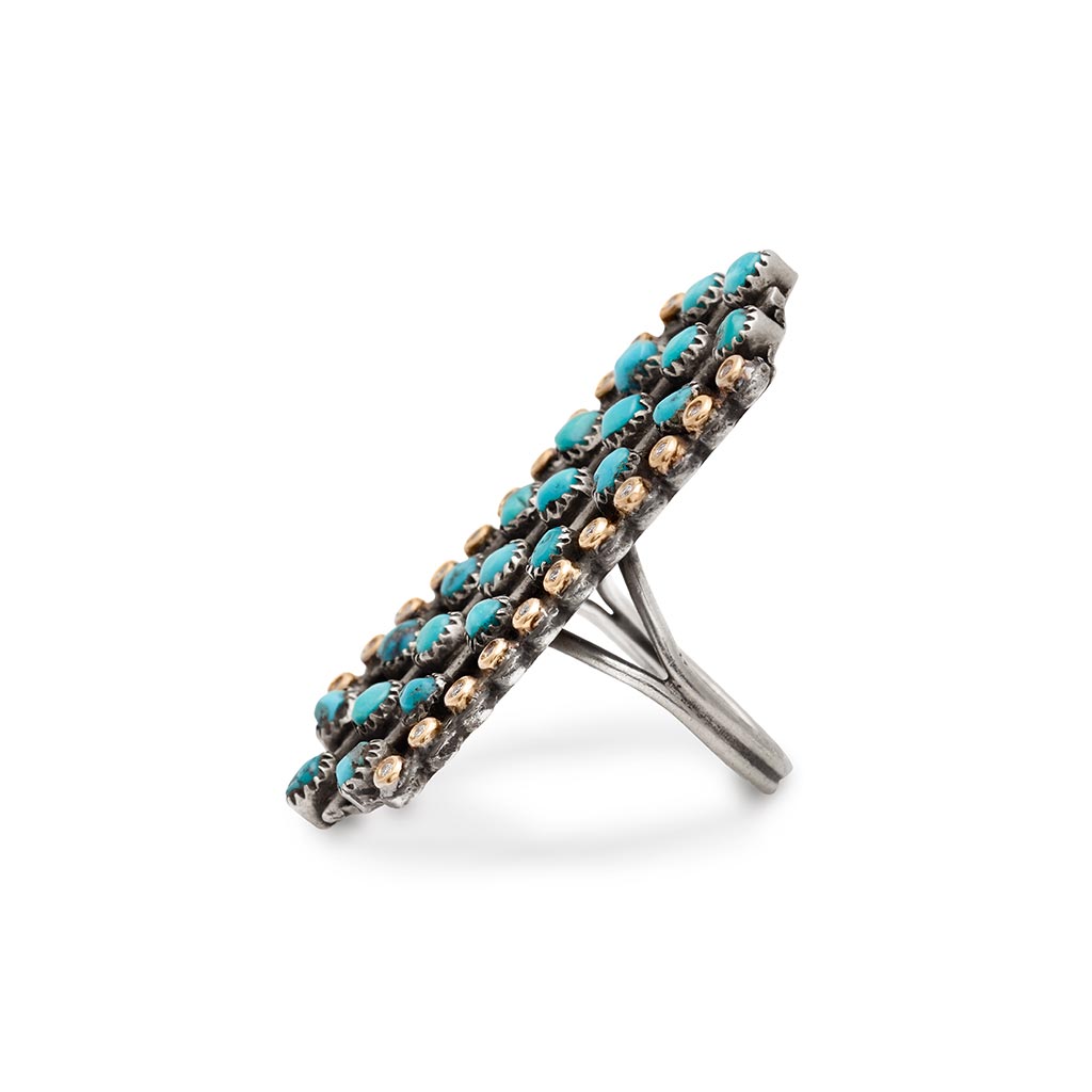 Angled side view a rectangular shaped, one of a kind ring with turquoise and white diamond stones set in sterling silver.