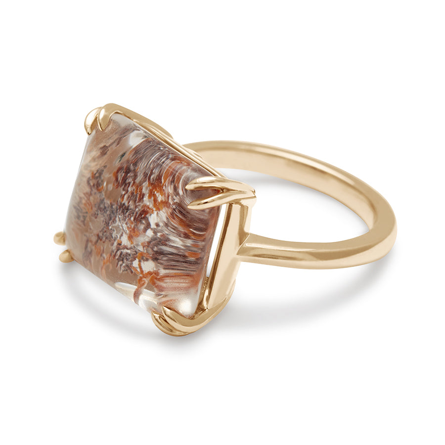 Angled view of a square quartz solitaire ring set in yellow gold.