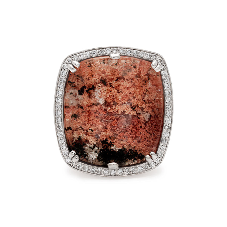 A square quartz surrounded by white diamond pave halo ring set in white gold.