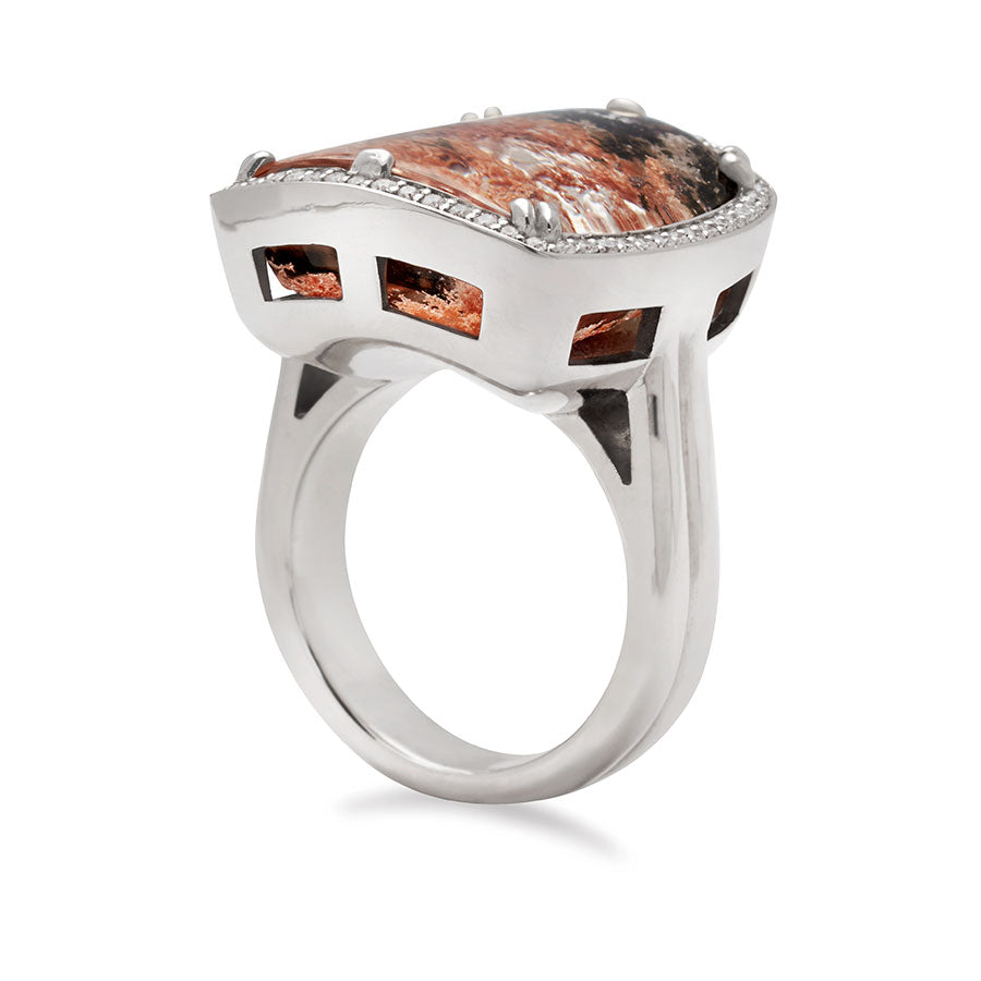 Angled side view of a square quartz surrounded by white diamond pave halo ring set in white gold.
