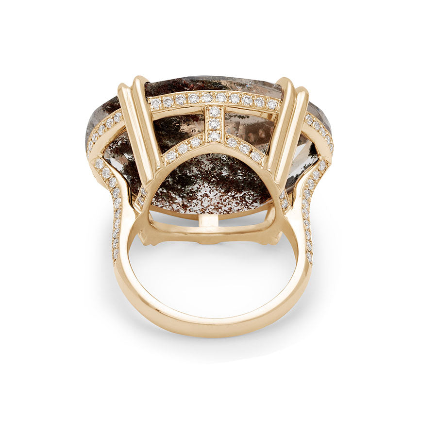 Upside down view of an oval east/west set quartz ring set in yellow gold with white diamonds surrounding the underneath of the stone and band.