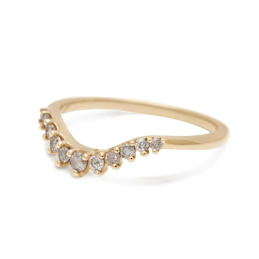 Angled view of a curved 11 grey diamond band set in yellow gold.