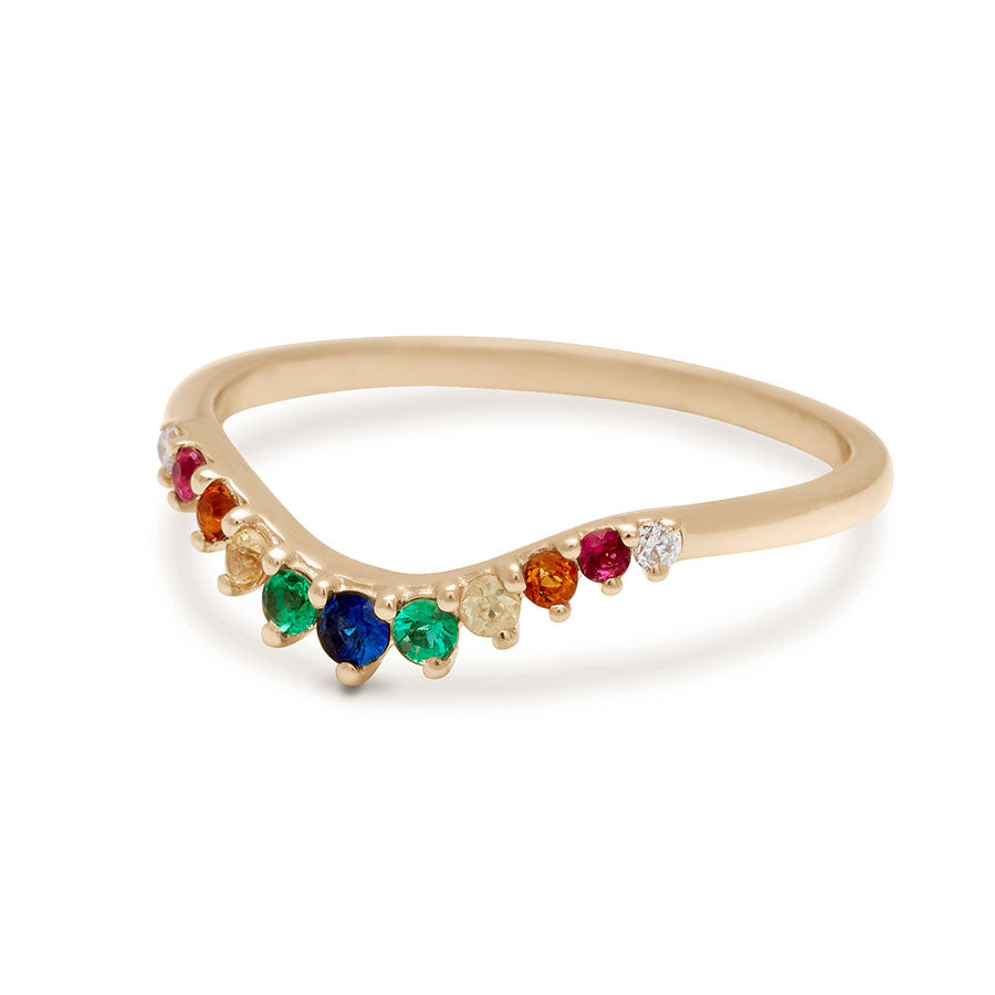 Angled view of a curved 11 rainbow colored gemstones band set in yellow gold.