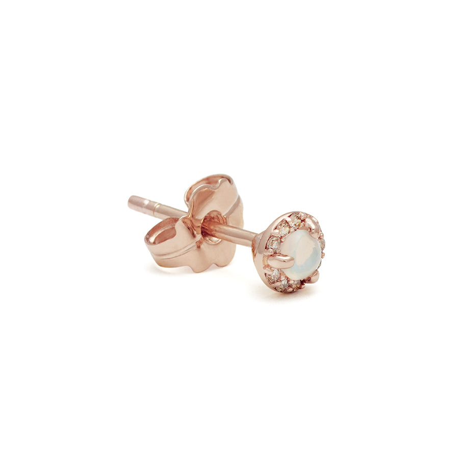 A single tiny opal center stone stud with a halo of champagne diamond set in rose gold.