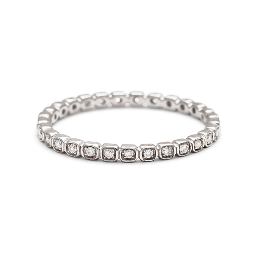 A tiny white diamond eternity band set in white gold.