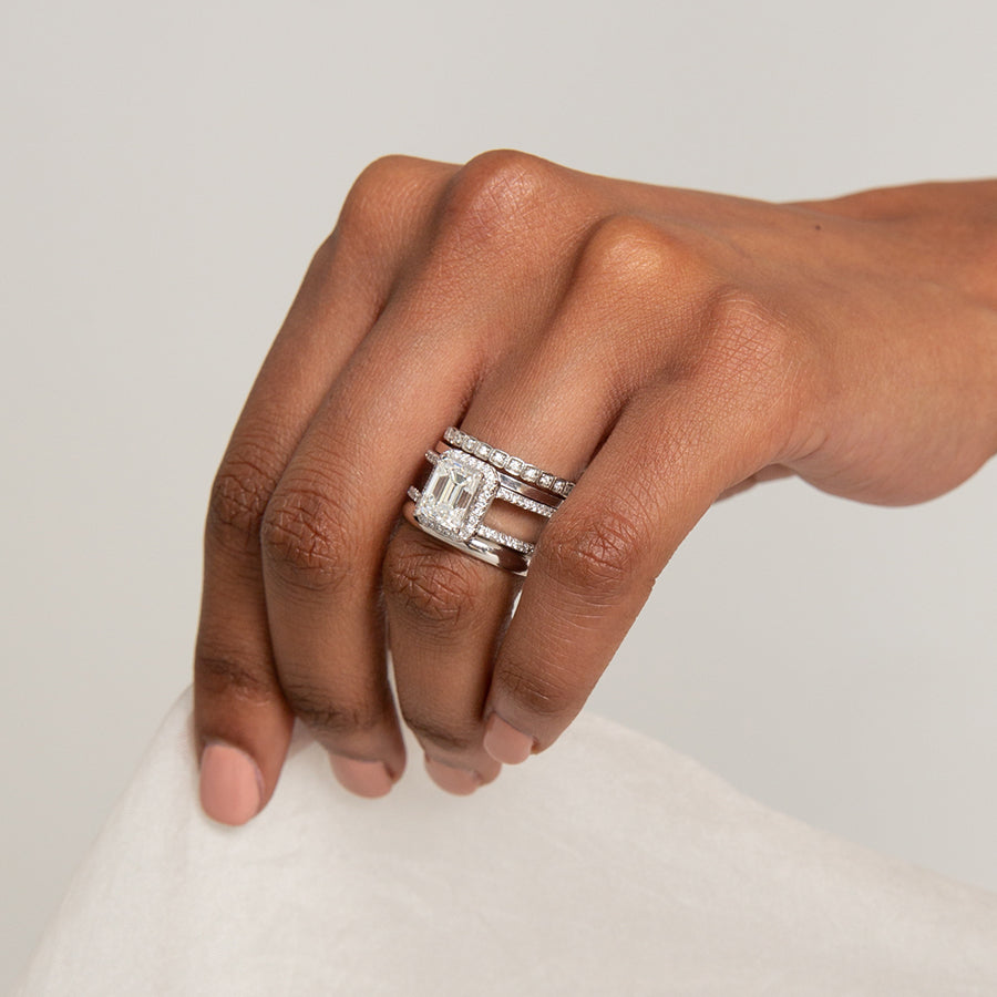A double banded engagment ring with an emerald shaped center white diamond set between two solid gold bands on a dark-complexion ring finger., White Gold, Rose Gold, Yellow Gold