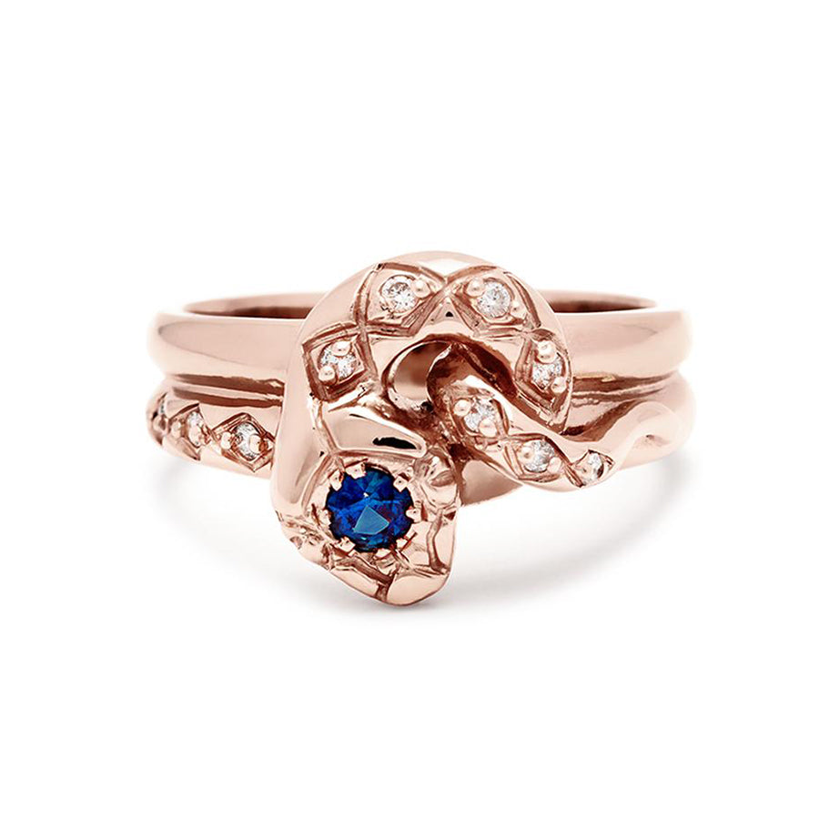 A serpent band with a blue sapphire center stone and white diamond accent stones around the head of the snake set in rose gold., Rose Gold