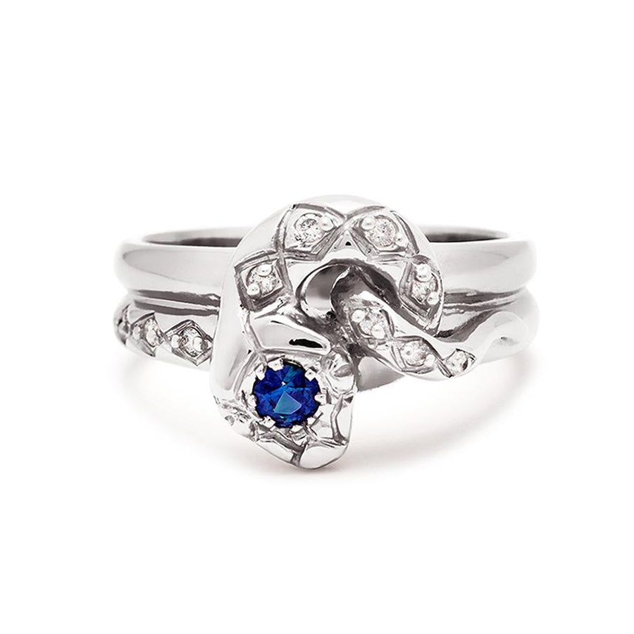 A serpent band with a blue sapphire center stone and white diamond accent stones around the head of the snake set in white gold., White Gold