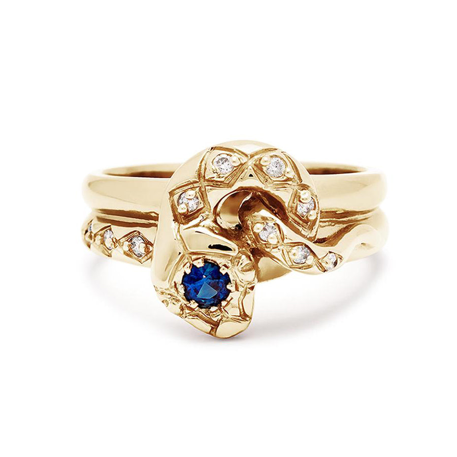 A serpent band with a blue sapphire center stone and white diamond accent stones around the head of the snake set in yellow gold., Yellow Gold