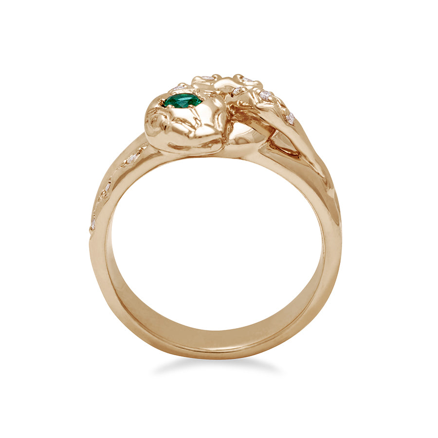 Side view of a serpent band with a green emerald center stone and white diamond accent stones around the head of the snake set in yellow gold., Yellow Gold