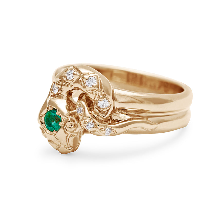 Angled view of a serpent band with a green emerald center stone and white diamond accent stones around the head of the snake set in yellow gold., Yellow Gold