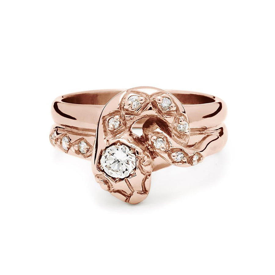 A serpent band with a white diamond center stone and white diamond accent stones around the head of the snake set in rose gold., Rose Gold