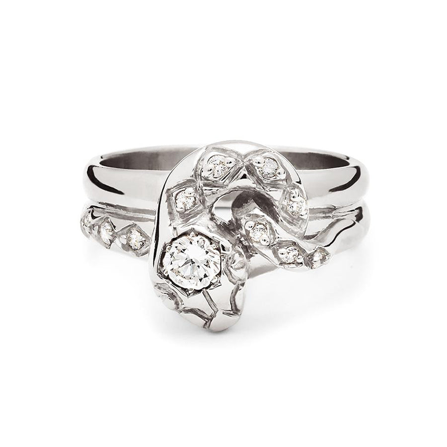 A serpent band with a white diamond center stone and white diamond accent stones around the head of the snake set in white gold., White Gold