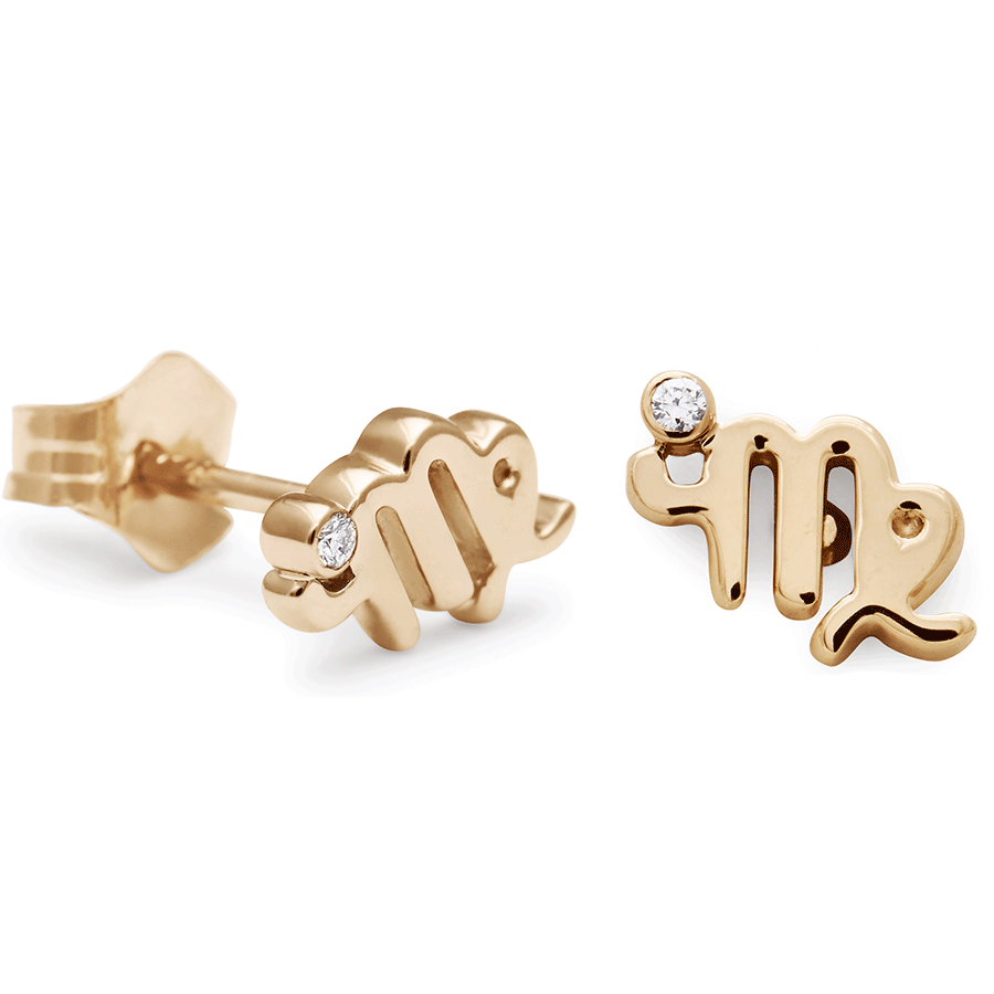 A pair of Virgo stud earrings set in yellow gold with a white diamond accent stone with one earring angled.