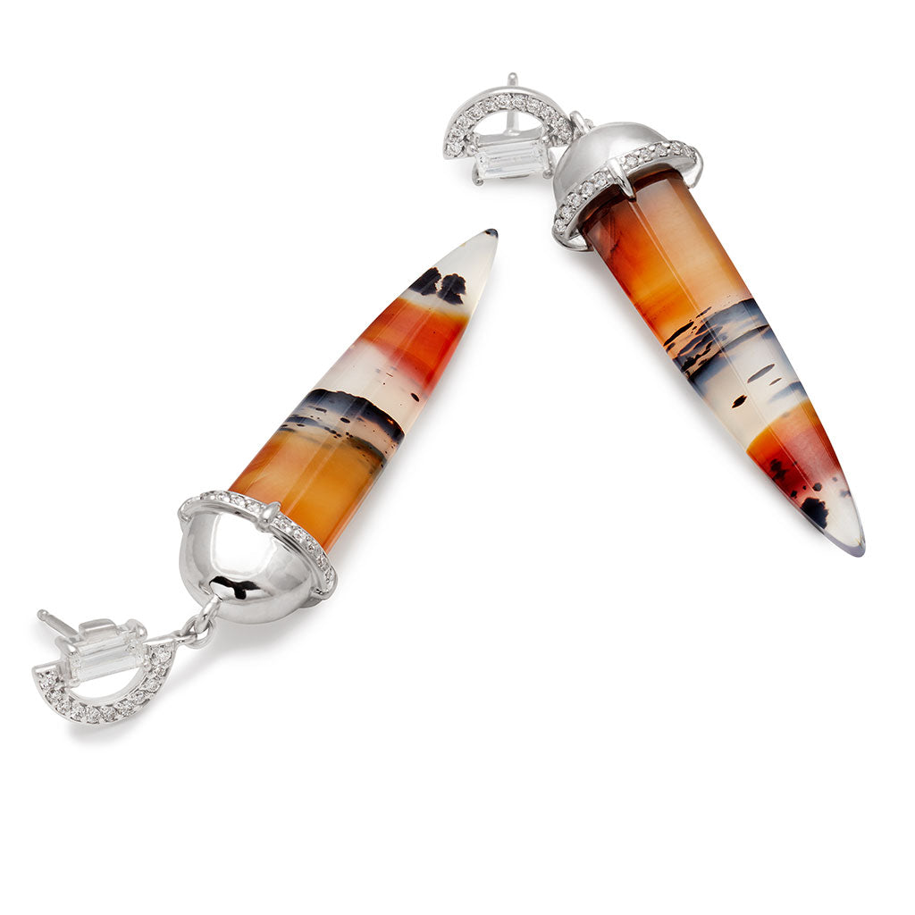 Upside down view of a pair of chalcedony drop earrings with a white diamond arc stud at the top set in white gold.