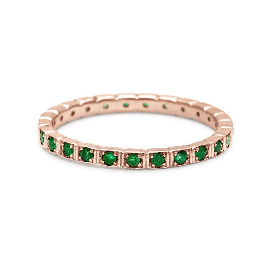 A straight band with emeralds set in eternity around the band set in rose gold., Rose Gold