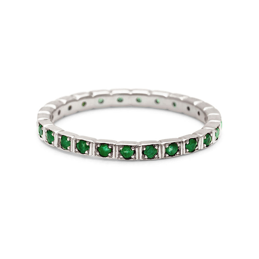 A straight band with emeralds set in eternity around the band set in white gold., White Gold